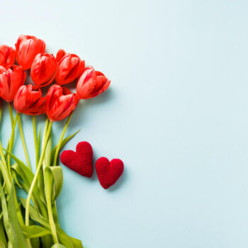 knitted hearts near tulips